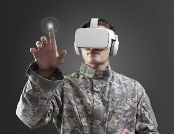Military in VR headset touching virtual screen